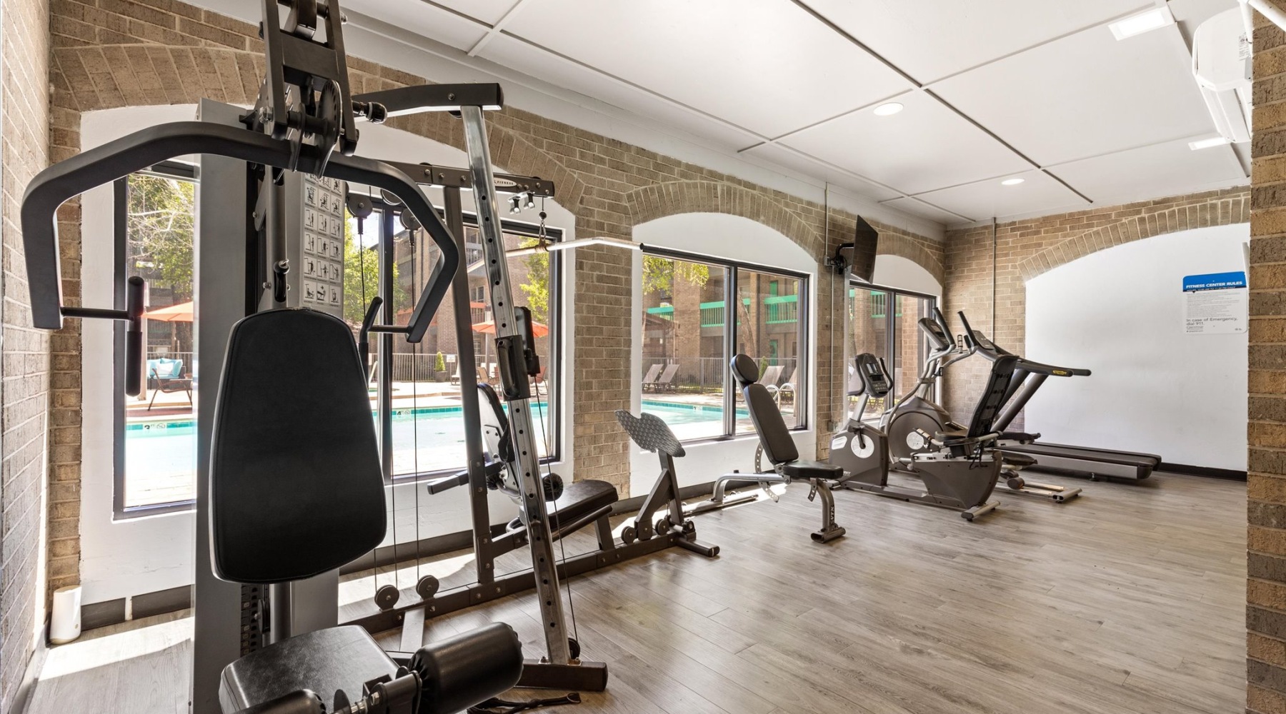 fitness center with rows of treadmills and modern style flooring