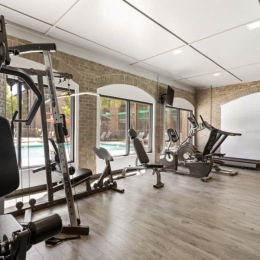 fitness center with open spaces and bright lighting through the windows