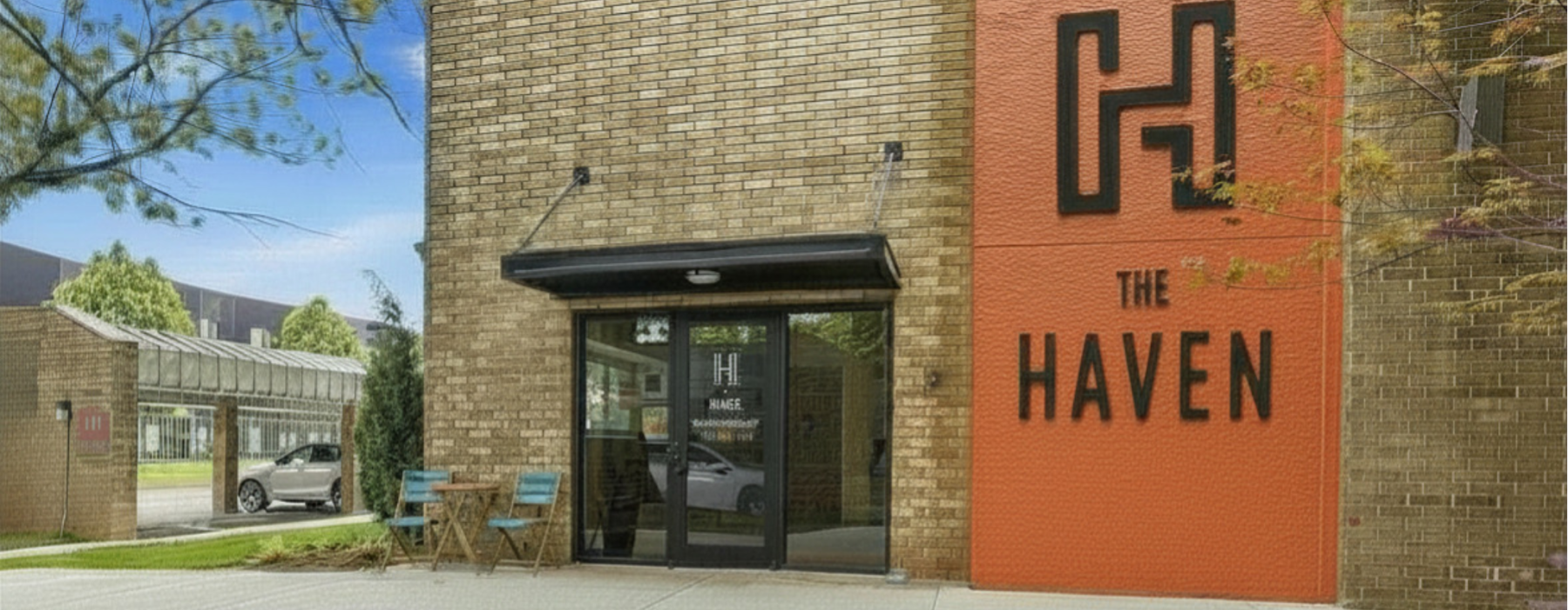 Front Office entrance with greenery and The Haven Sign 