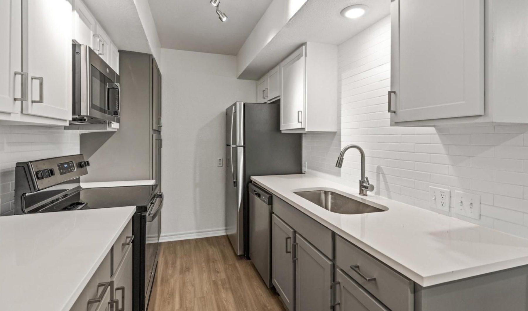 a kitchen with white cabinets