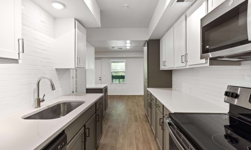 a kitchen with white cabinets